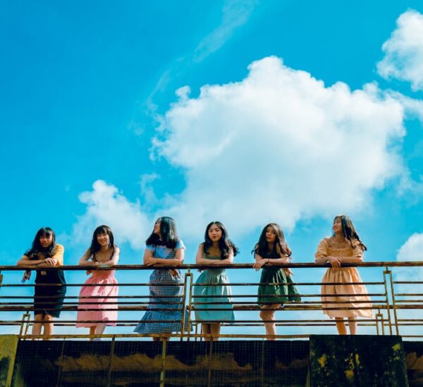 A diverse group of joyful women laughing and relaxing outdoors during a women-only travel retreat in 2025, surrounded by nature—symbolizing freedom, empowerment, and soulful connection.