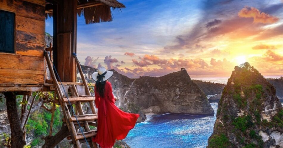Woman embracing the sunrise in the mountains, symbolizing a new beginning after heartbreak
