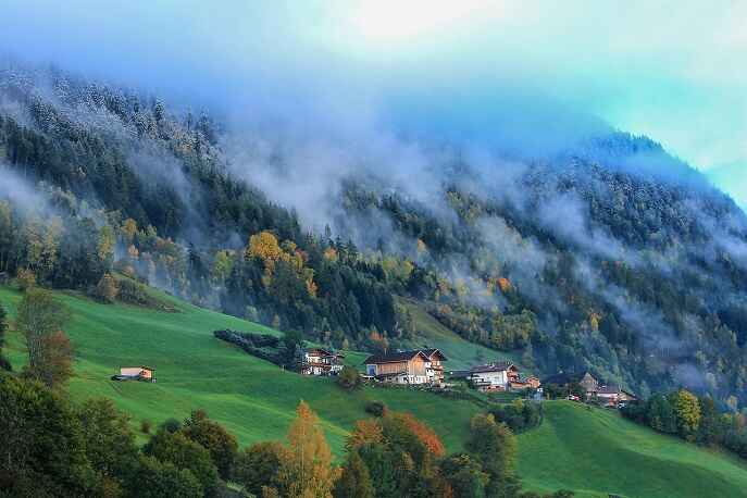 Misty alpine slopes and scattered houses in the peaceful Haa Valley of Bhutan