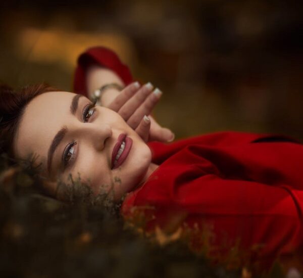 Woman looking rejuvenated post-flight with glowing skin and red lips