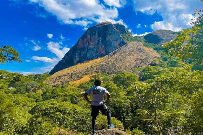 A hiker admiring the majestic Mount Mulanje landscape in Malawi.