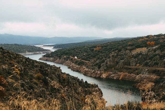 Quiet river snaking through green karst mountains in rural Laos