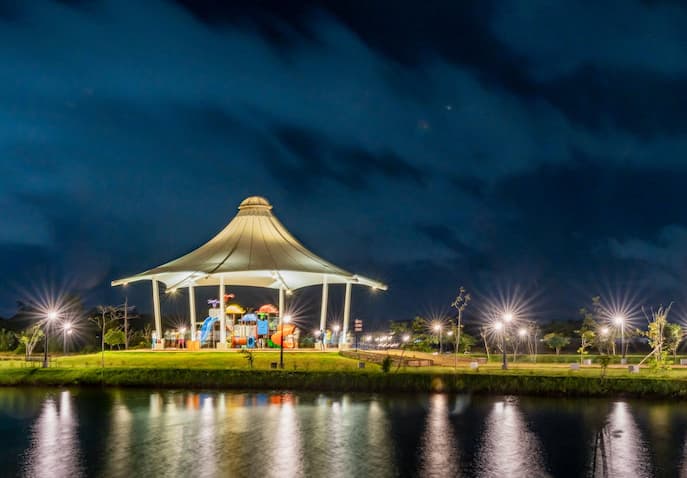 Women celebrating by a lakeside at night in Sri Lanka during an affordable detox wellness retreat