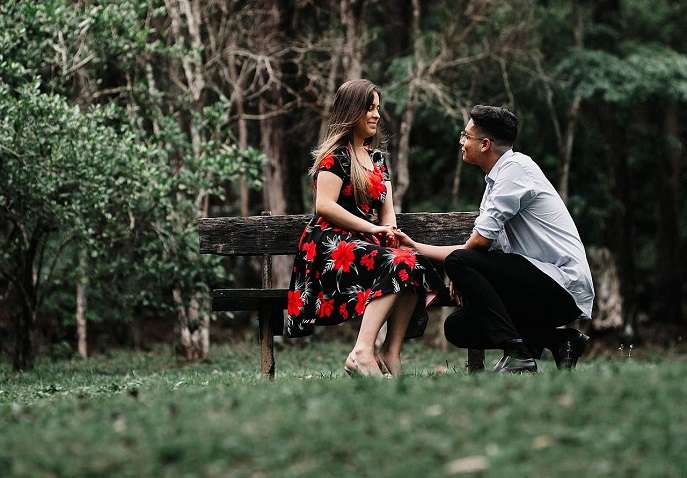 A couple having a heartfelt conversation on a park bench during a quiet Valentine’s Day outing