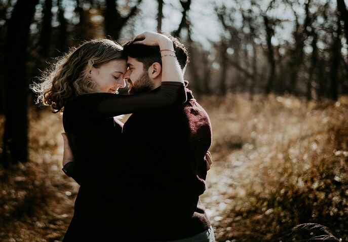 Couple relaxing together surrounded by trees in a peaceful natural setting at sunset